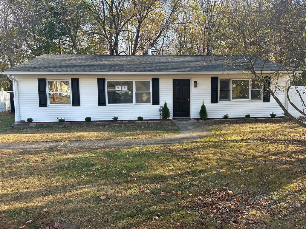 Single story home with a front lawn