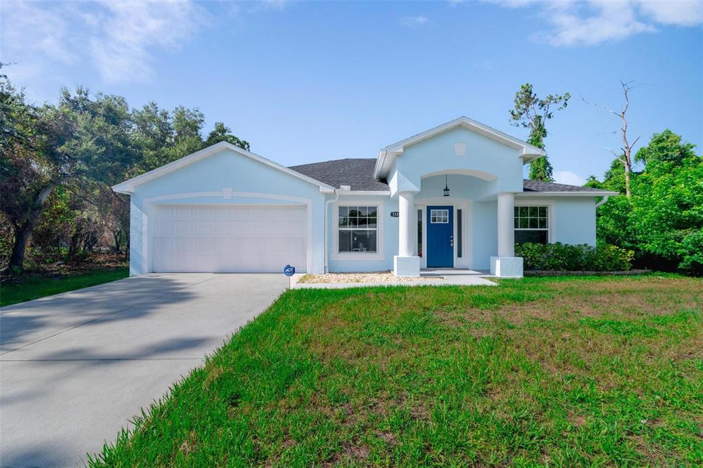 a front view of a house with a yard and garage