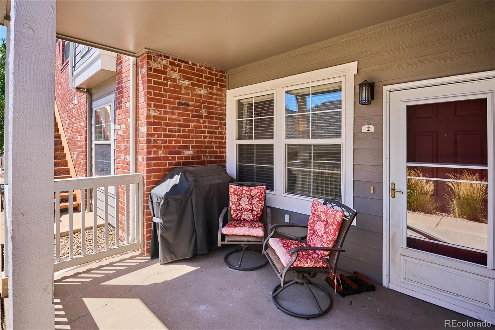 a balcony with couch and chairs