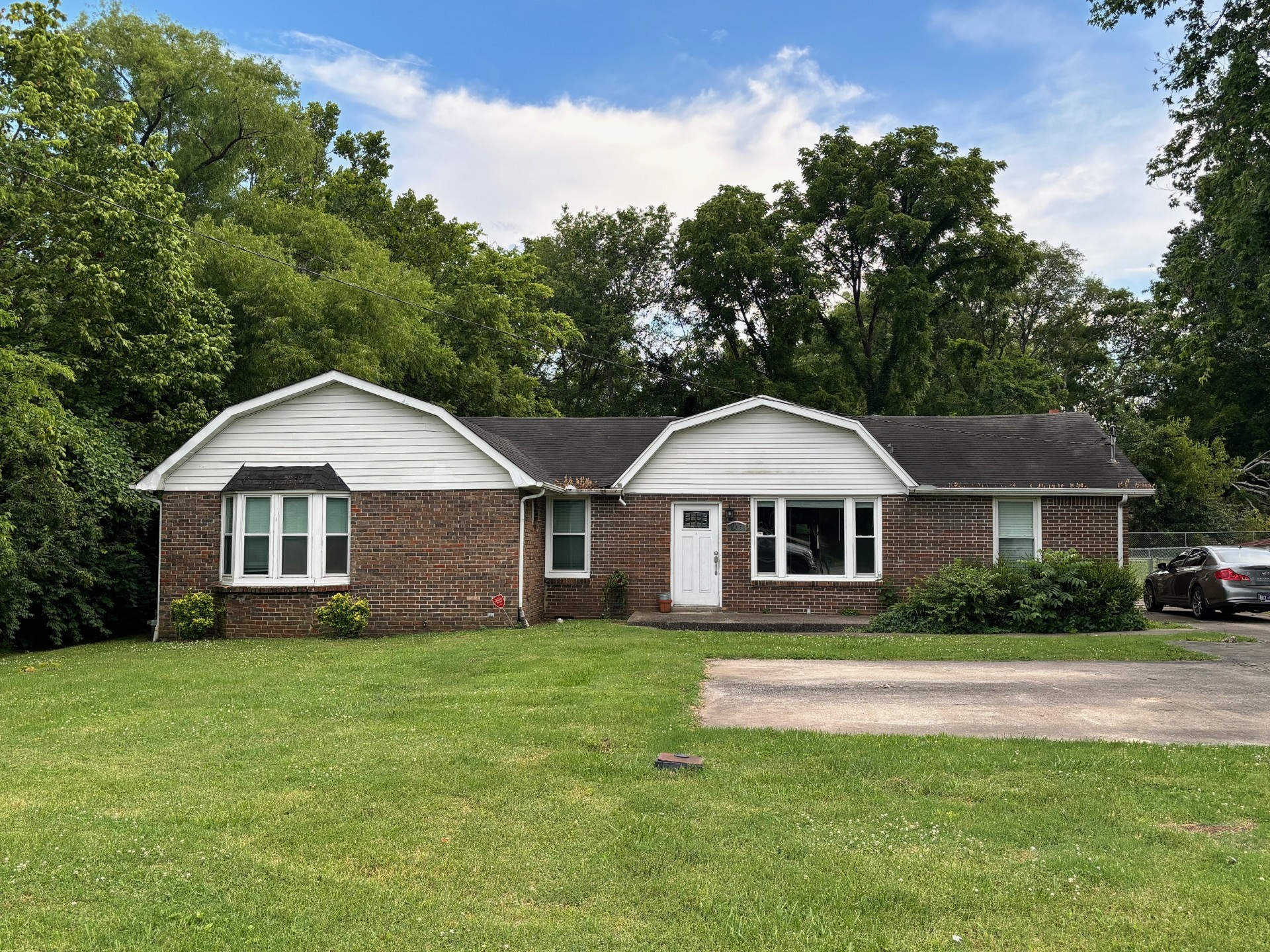 a front view of house with yard and green space