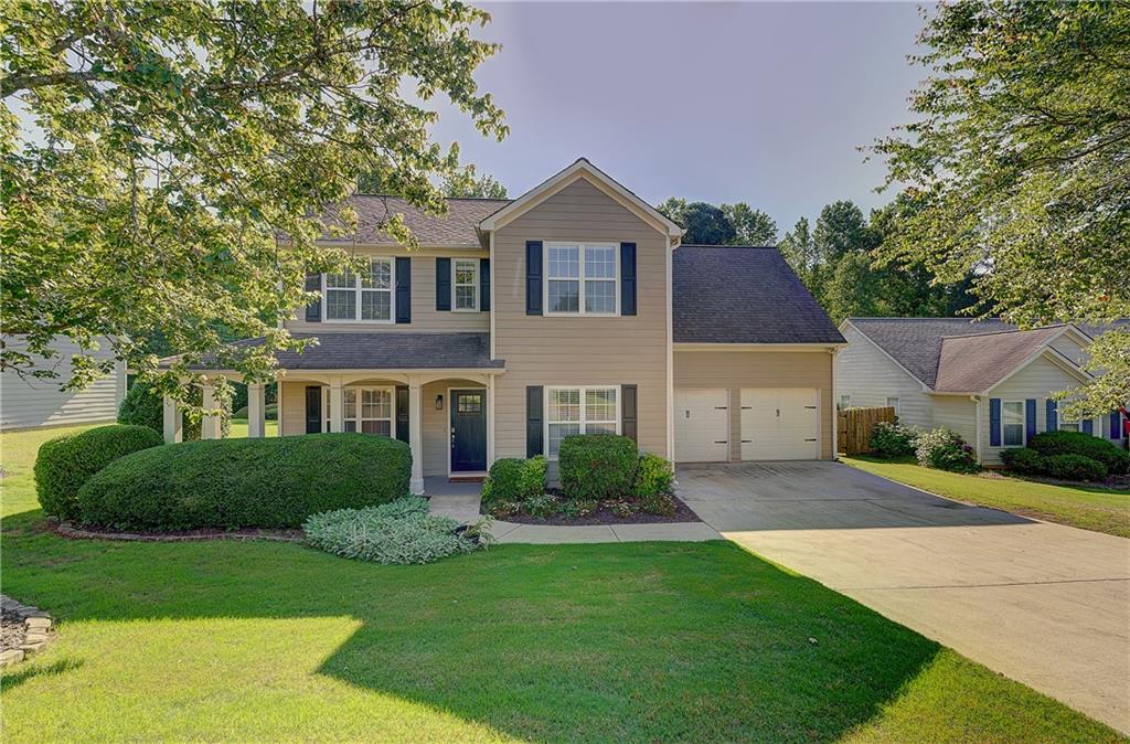 a front view of a house with a yard and garage