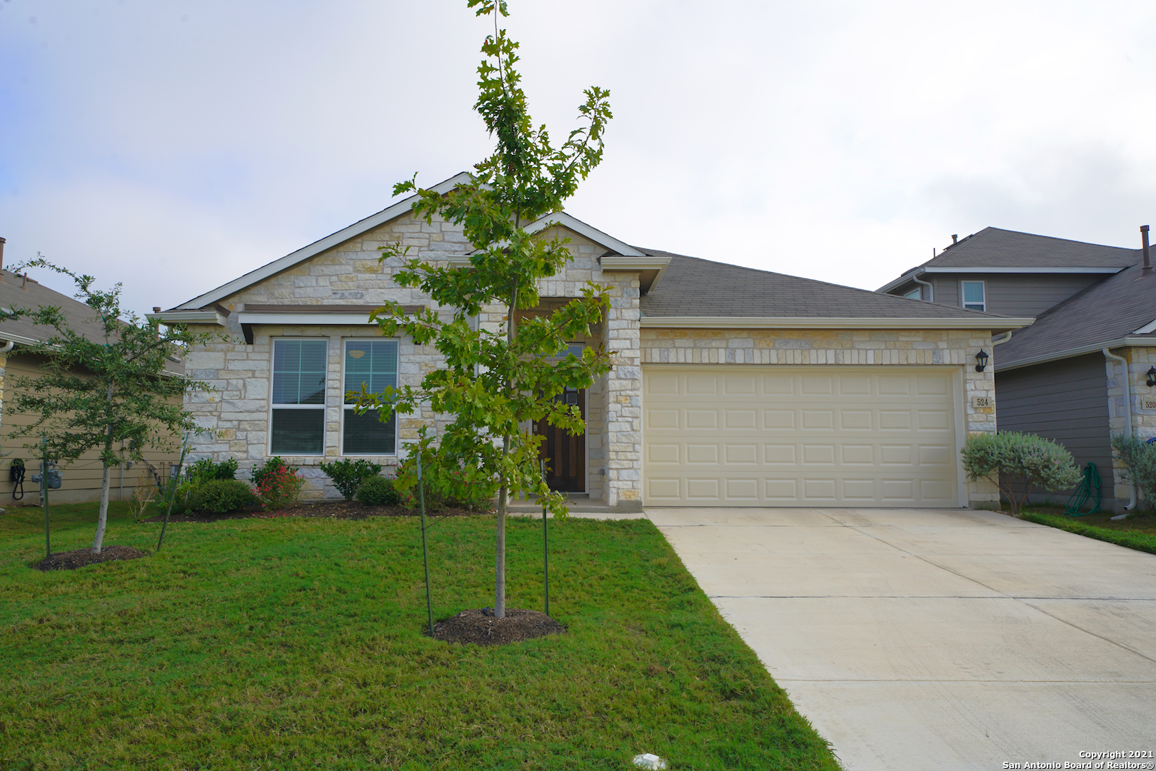 a front view of house with yard and green space