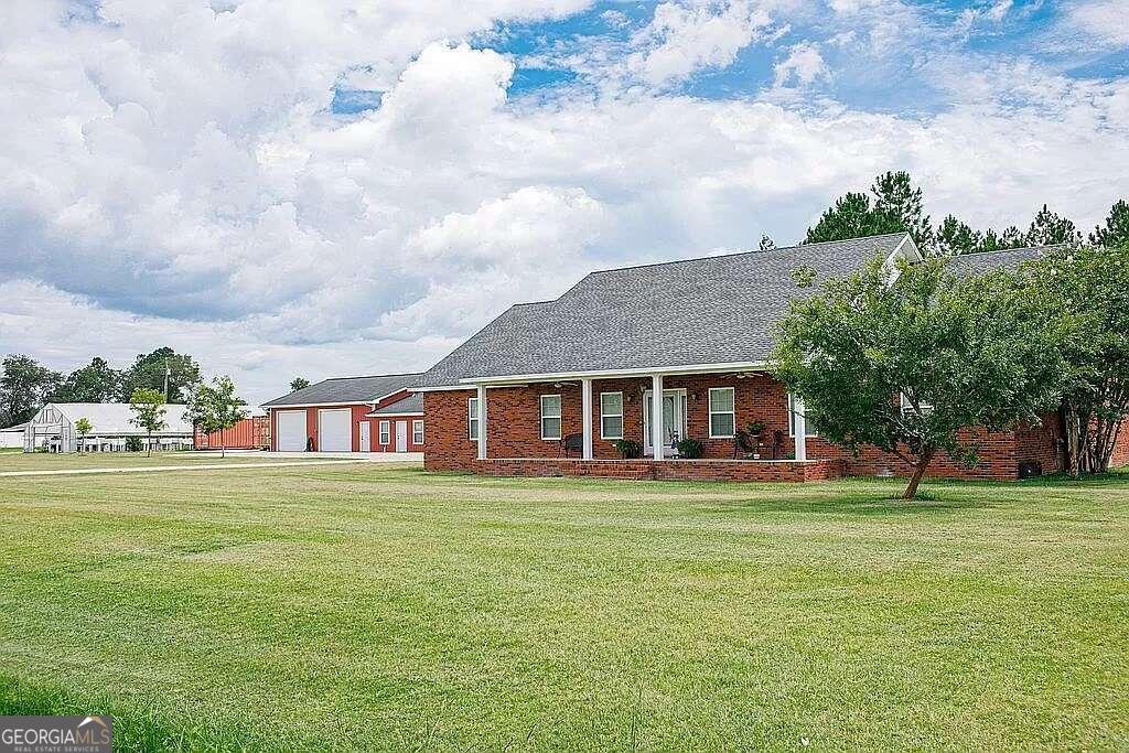 a front view of a house with a garden