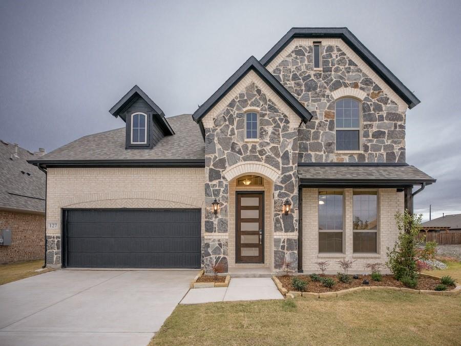 a front view of a house with yard