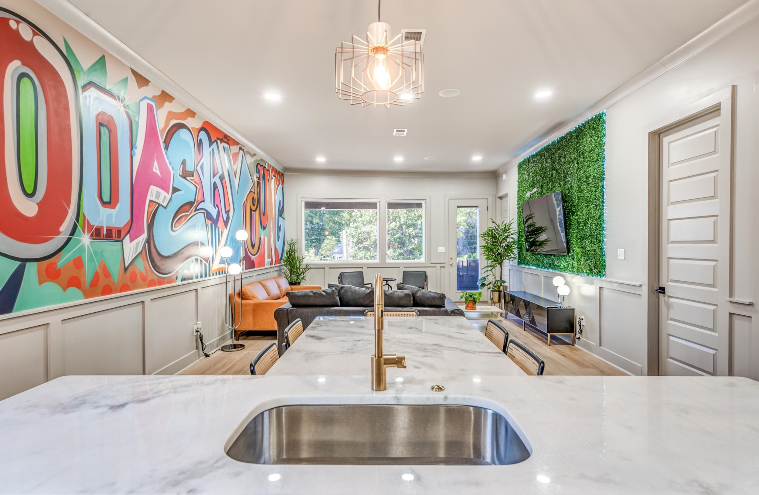 a kitchen with stainless steel appliances kitchen island granite countertop a sink and window