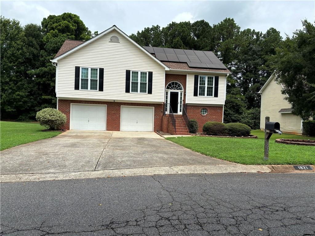 a front view of a house with a yard and garage