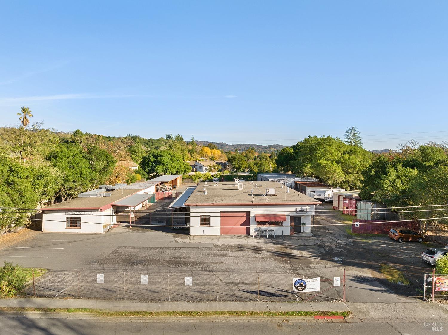 an aerial view of a house with a yard basket ball court and outdoor seating