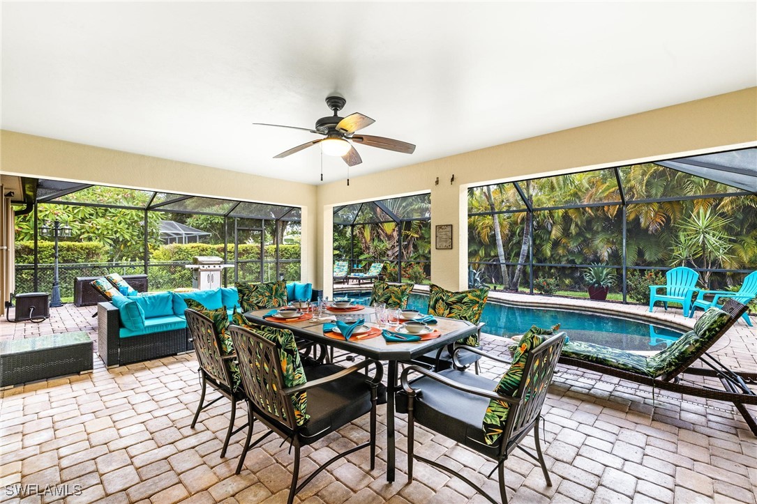 a dining room with furniture a rug and a floor to ceiling window