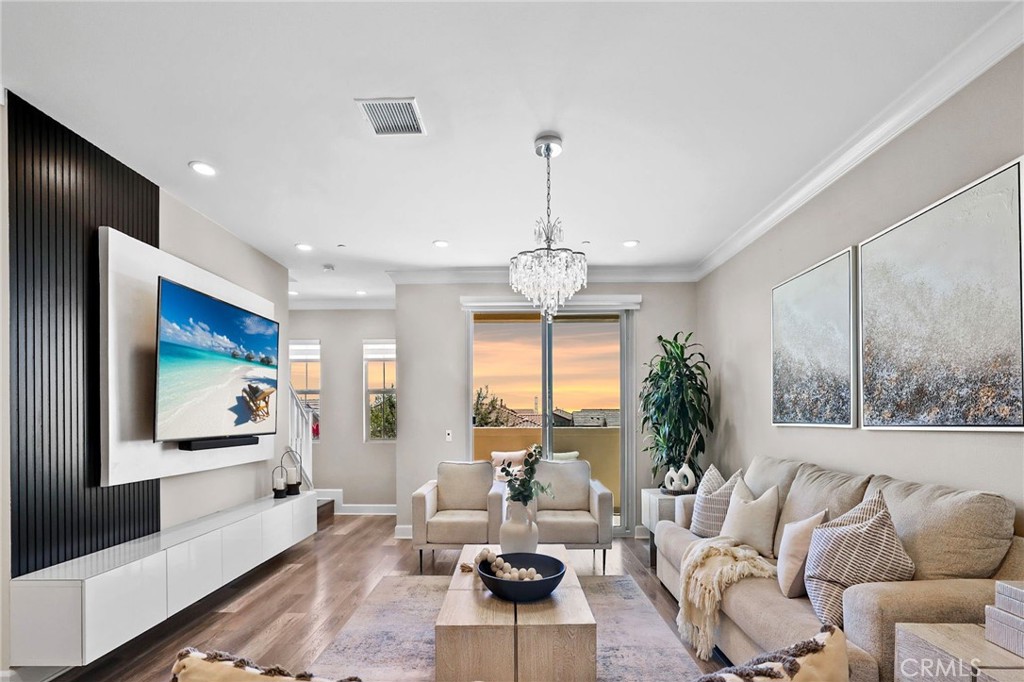 a living room with furniture and a chandelier