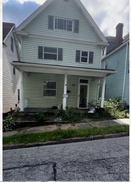 a front view of a house with a yard and outdoor seating