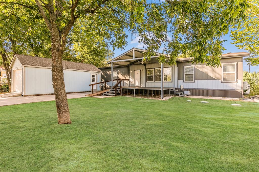 a view of a house with a backyard