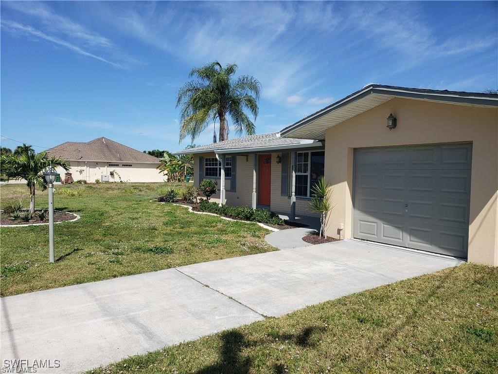 a front view of a house with a yard and garage