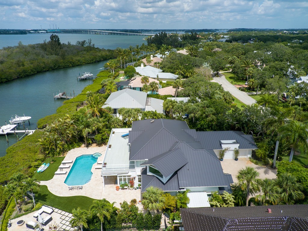 an aerial view of house with yard and ocean view