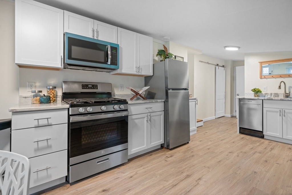 a kitchen with a stove microwave and refrigerator