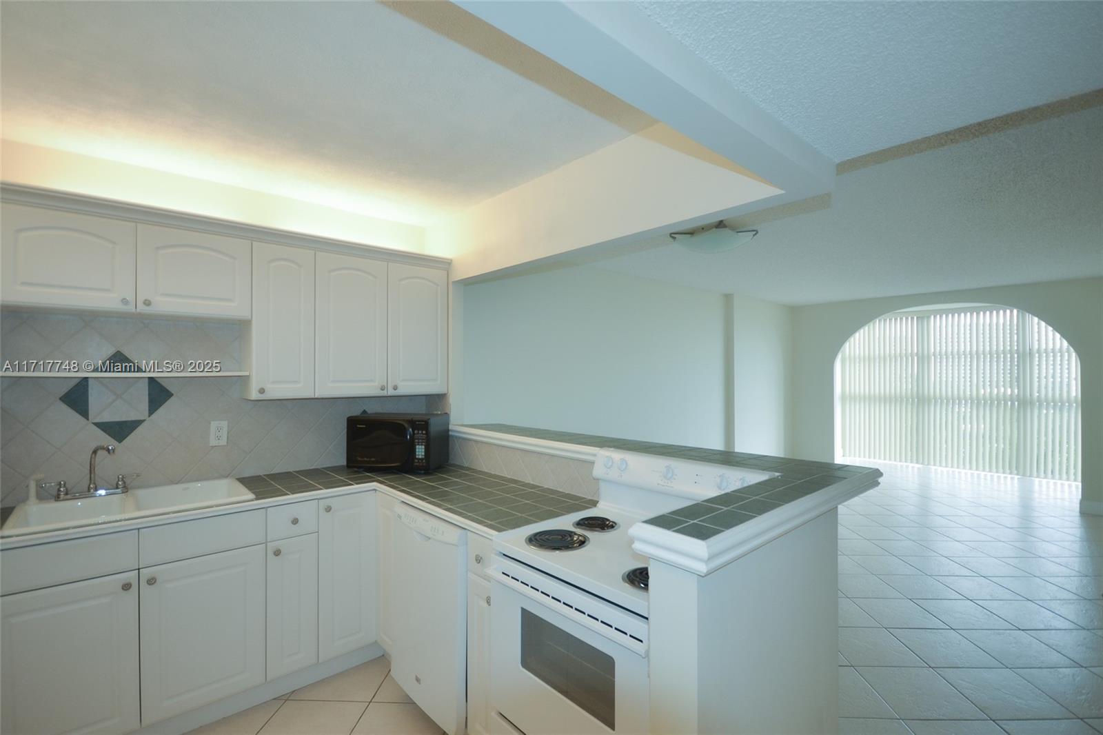 a kitchen with a stove and white cabinets