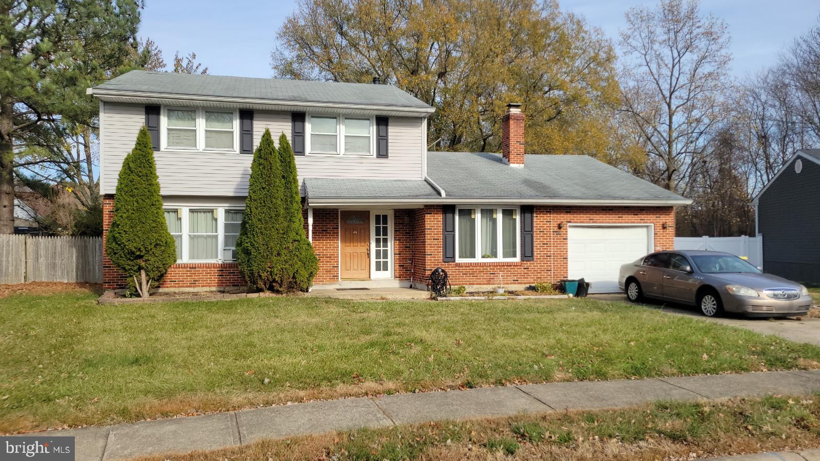 a front view of a house with a yard and porch