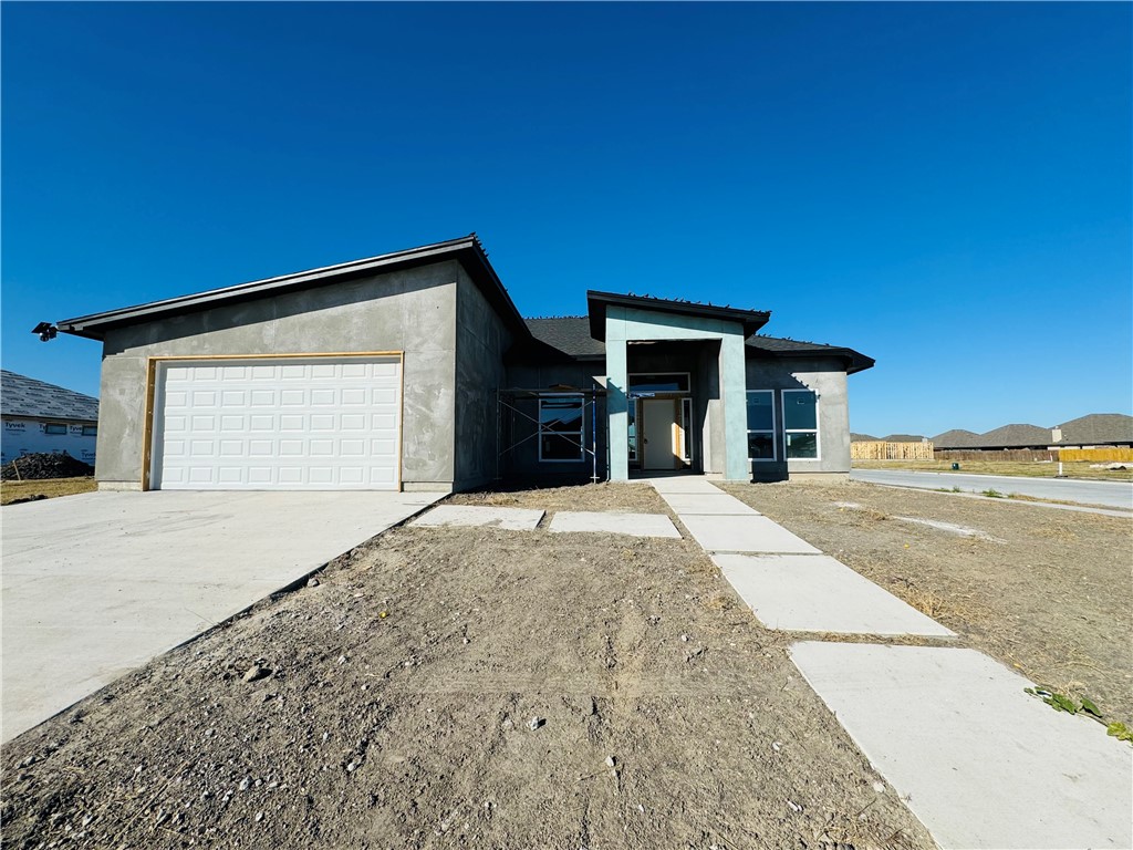 a view of garage with yard