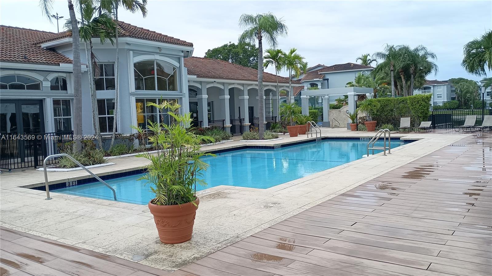 a view of house with swimming pool outdoor seating