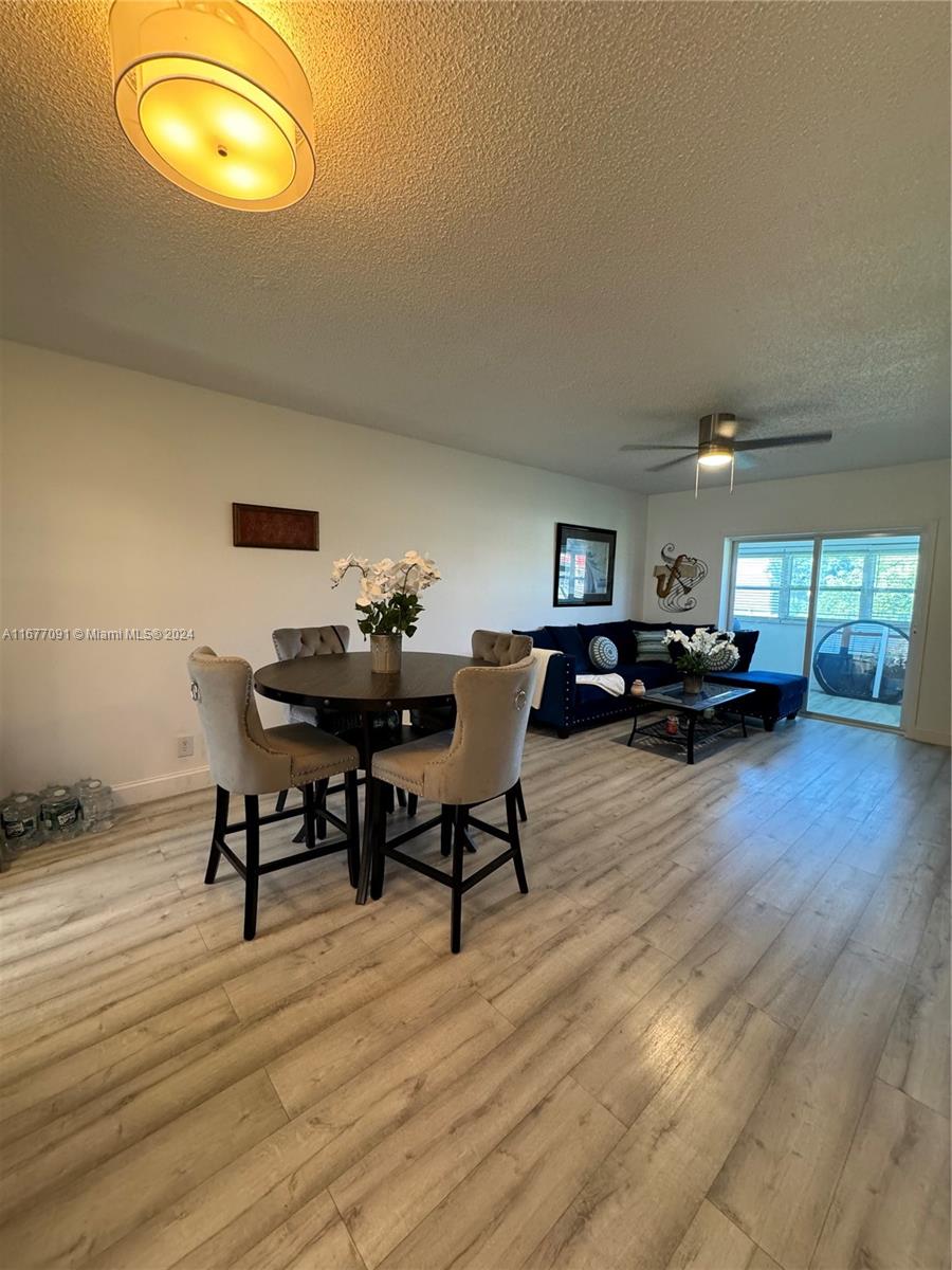 a living room with furniture and a dining table