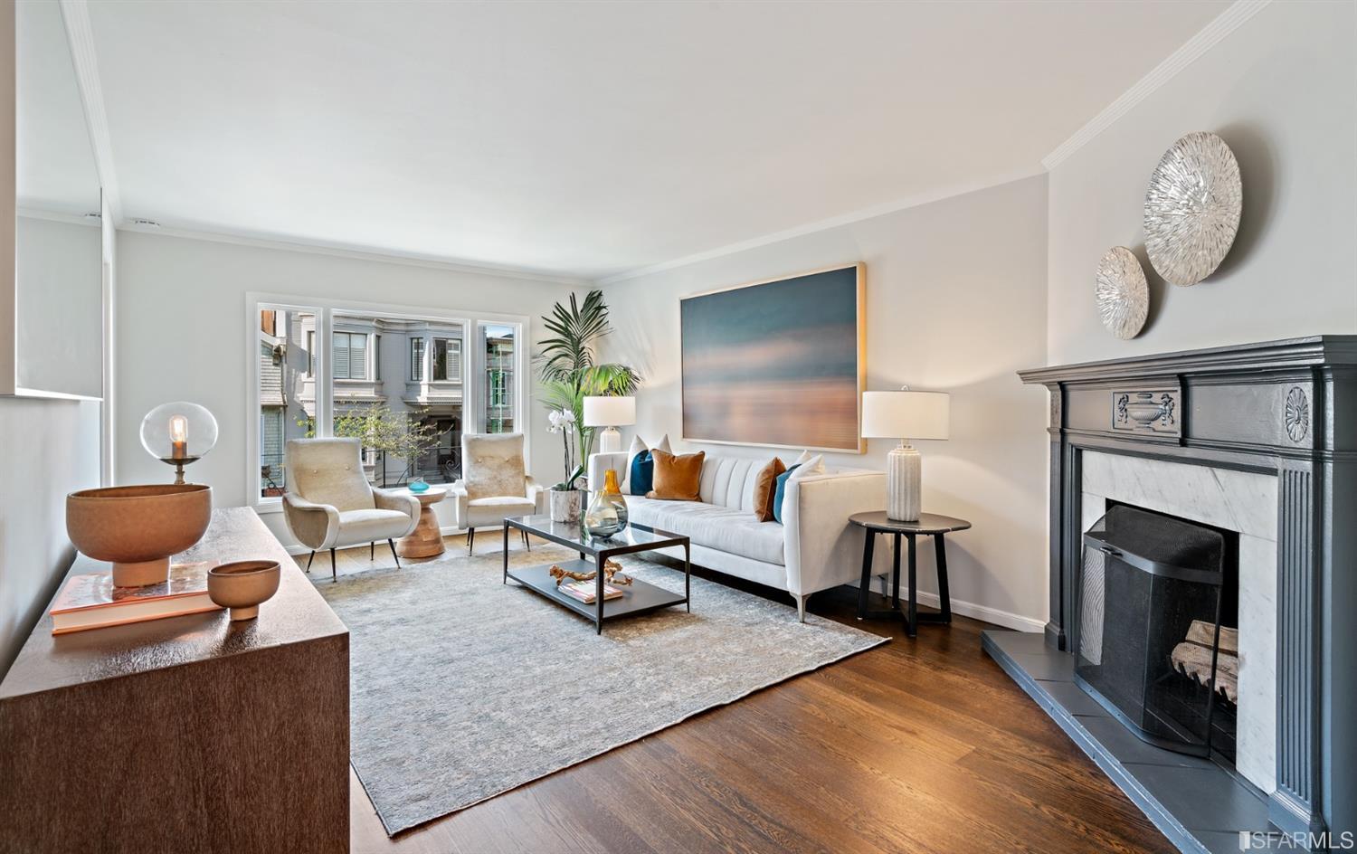 a living room with furniture a fireplace and a flat screen tv