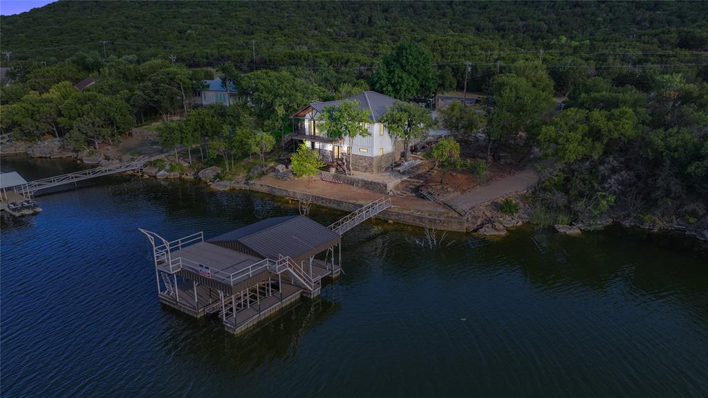 an aerial view of a house with garden space and lake view