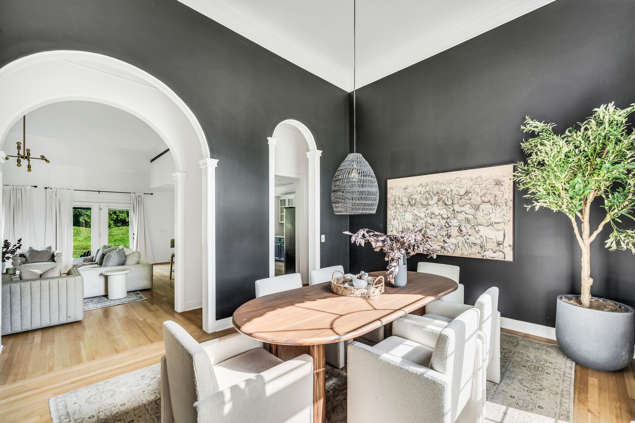 a dining room with furniture a chandelier and wooden floor