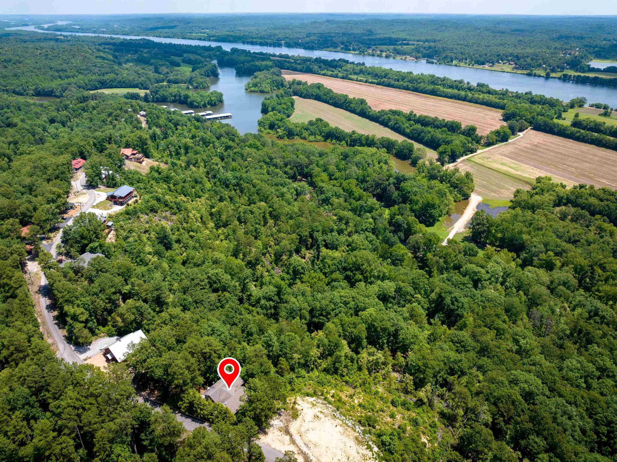 an aerial view of a house with a yard and lake view