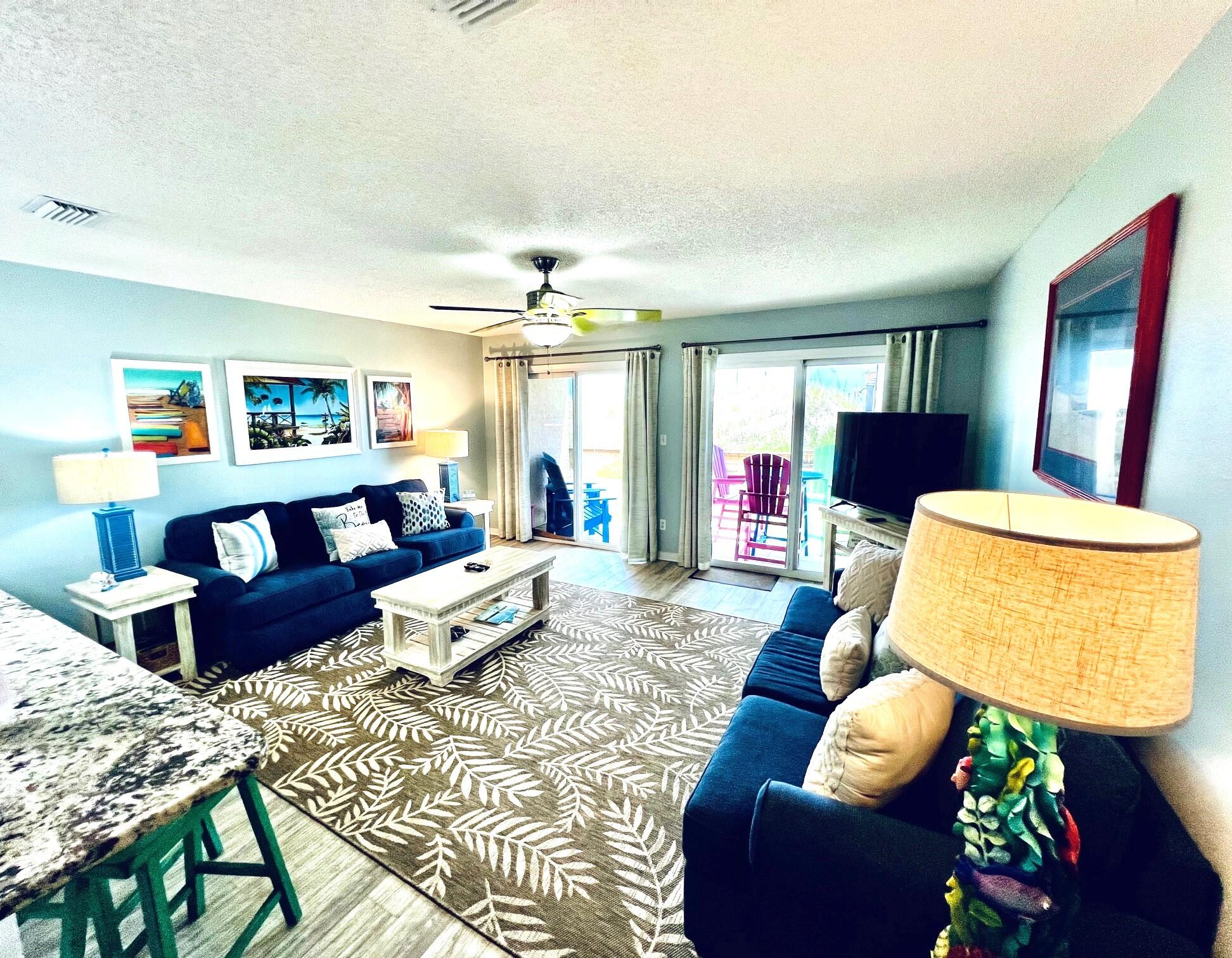 a living room with furniture and a potted plant