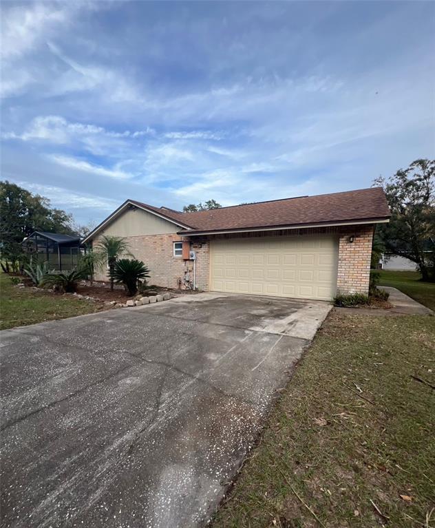 a view of a house with a yard and garage