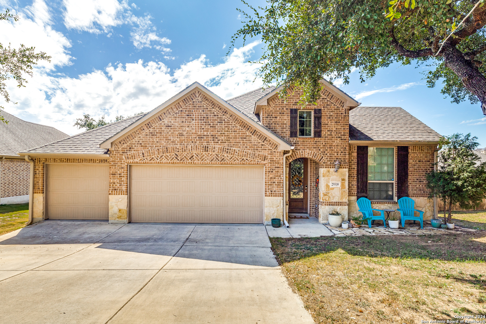 a front view of a house with a yard and garage