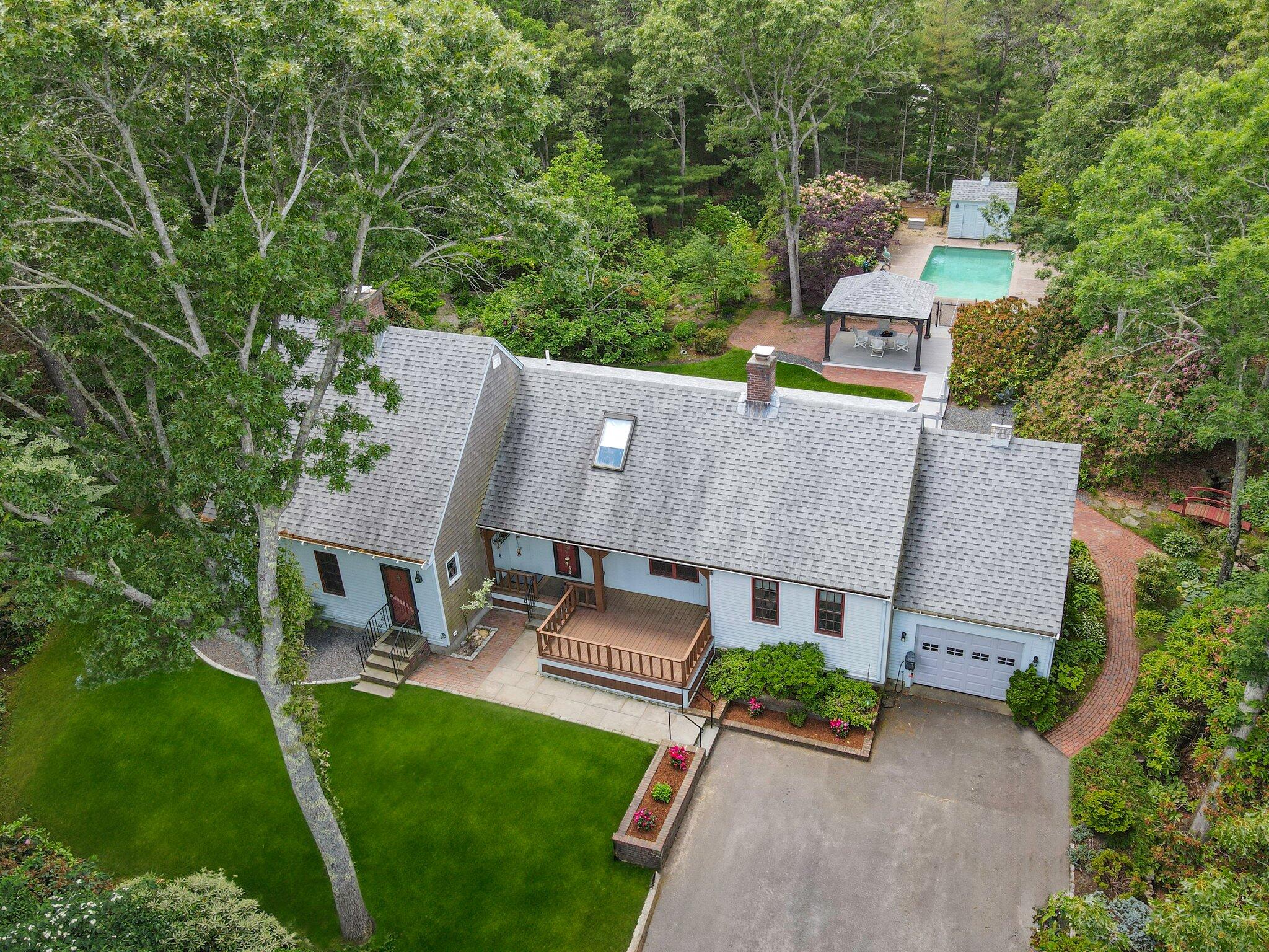 an aerial view of a house with garden space and street view