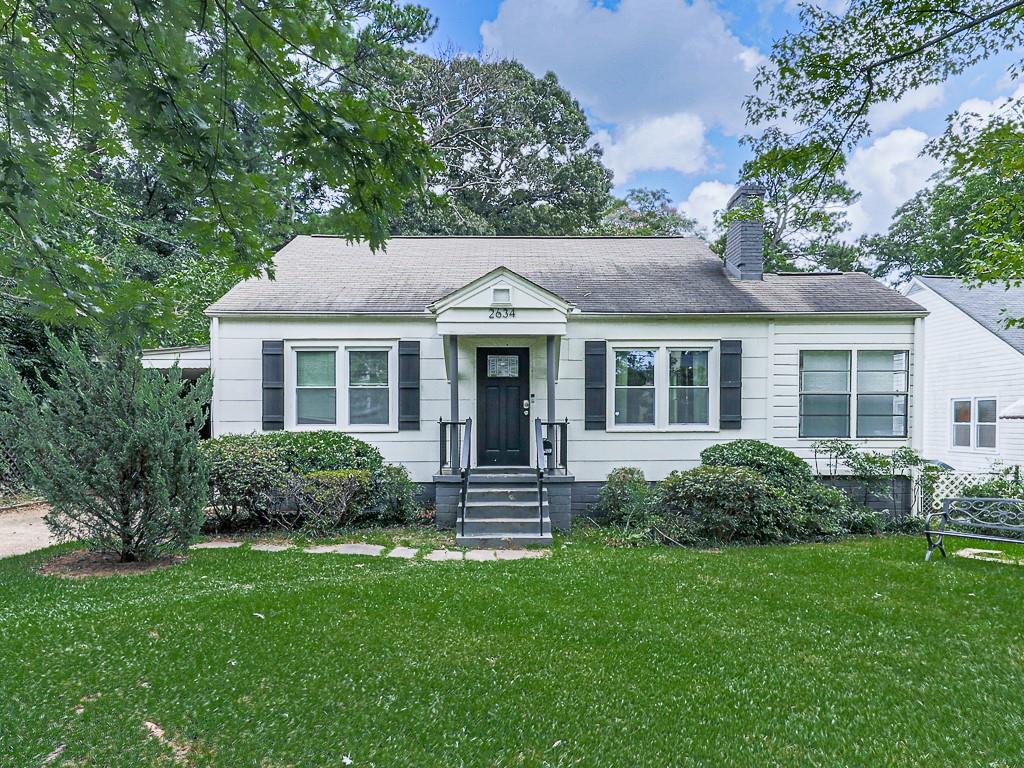 a front view of house with yard and green space