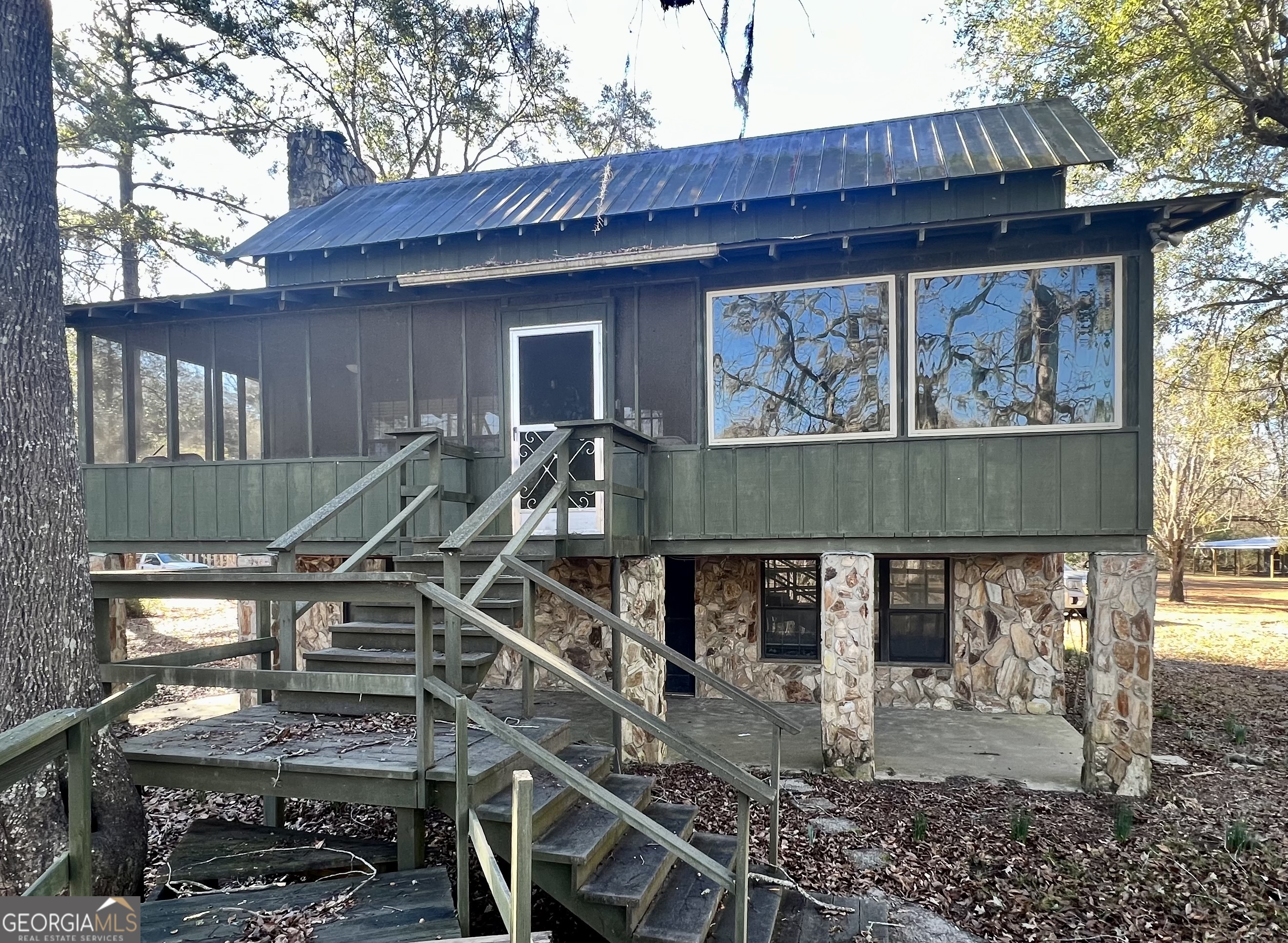 a view of a house with wooden deck and furniture