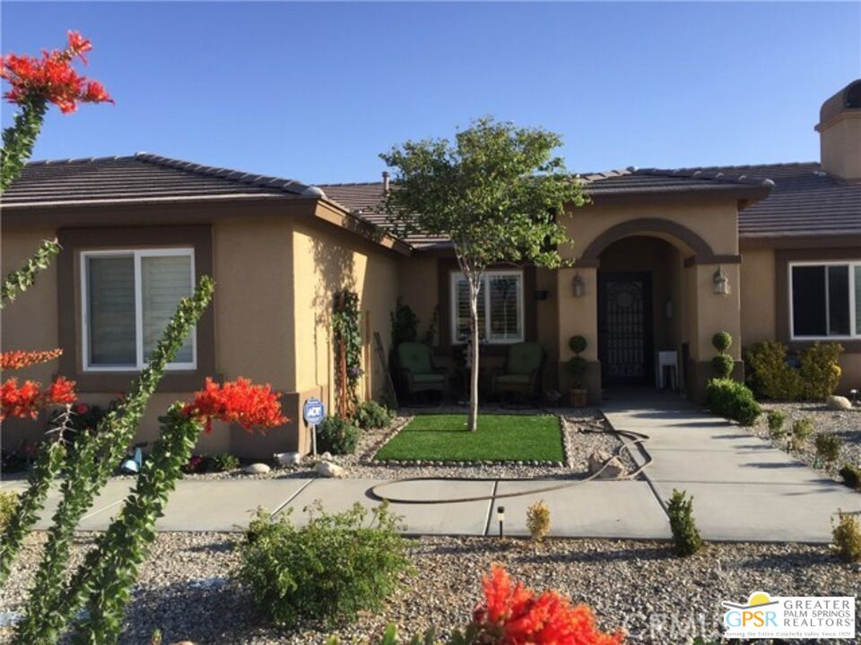 a front view of a house with flower plants