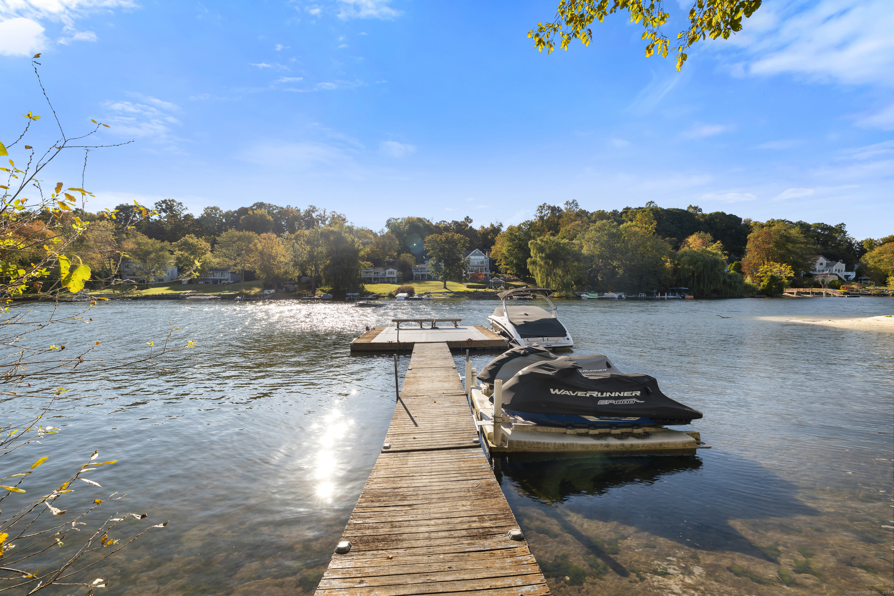 a view of a lake with a car parked on the road