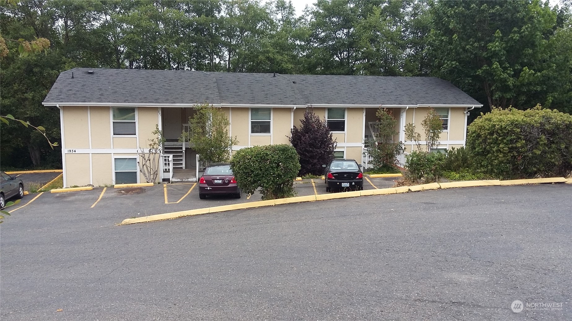 a view of a house with a patio and a yard