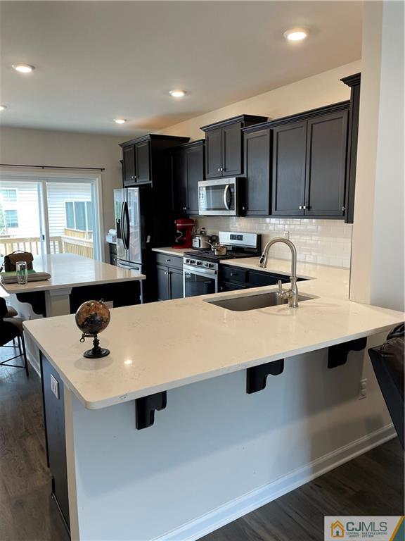 a kitchen with a sink a stove and chairs