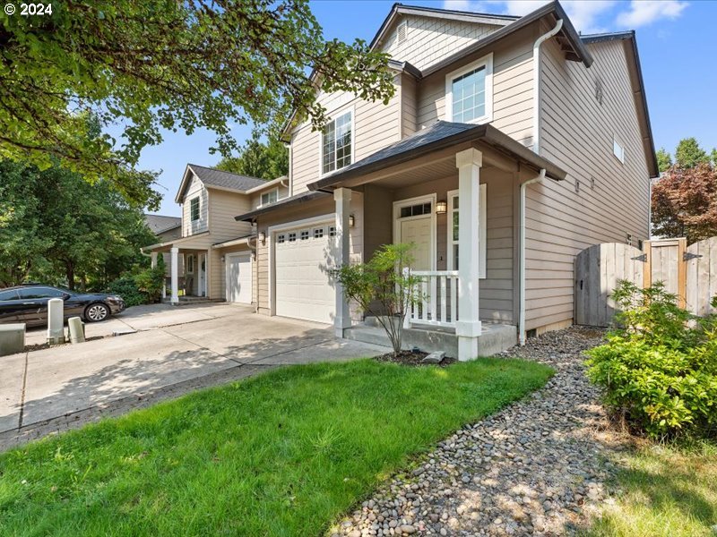 a view of a house with a yard and pathway