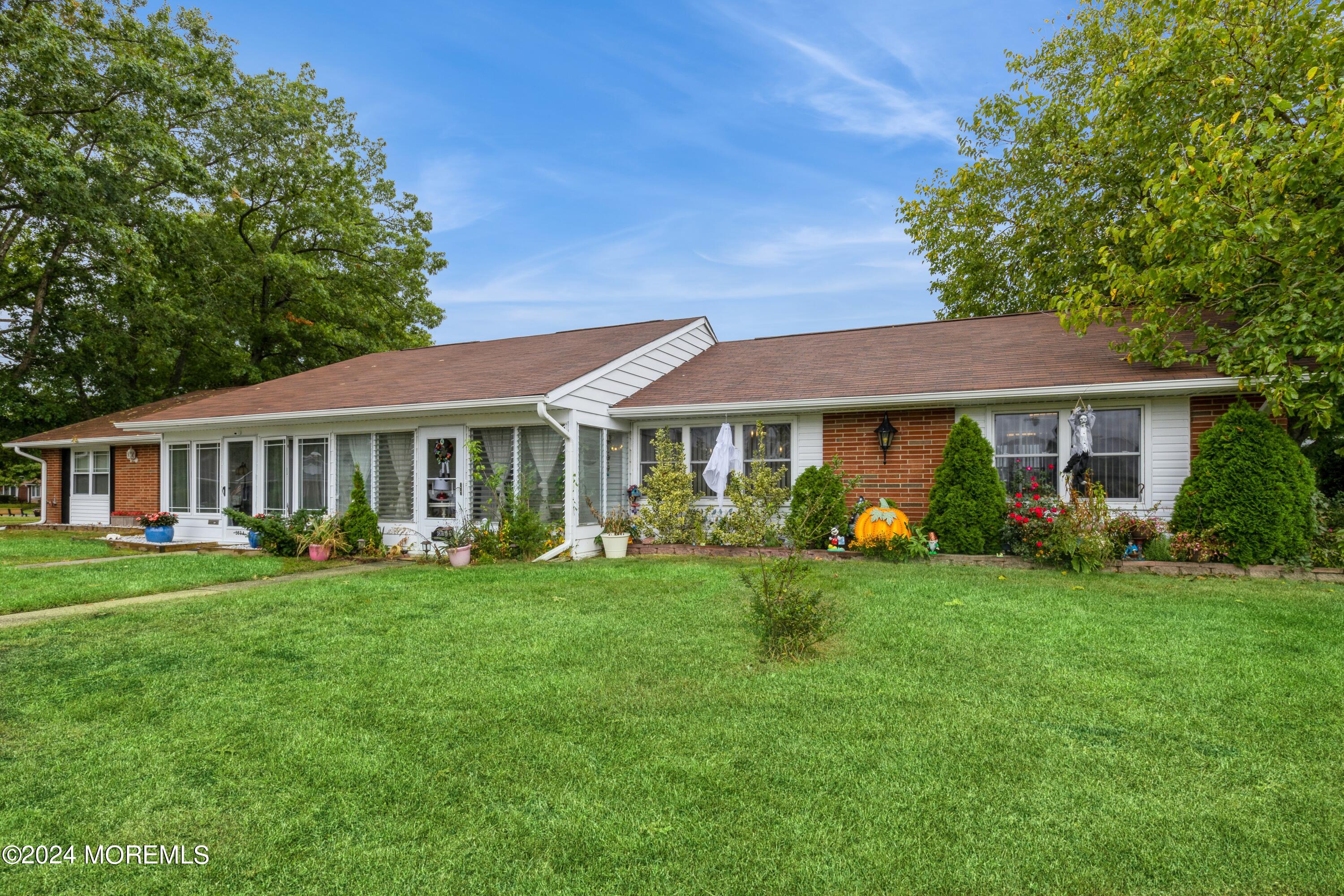 a front view of a house with a garden