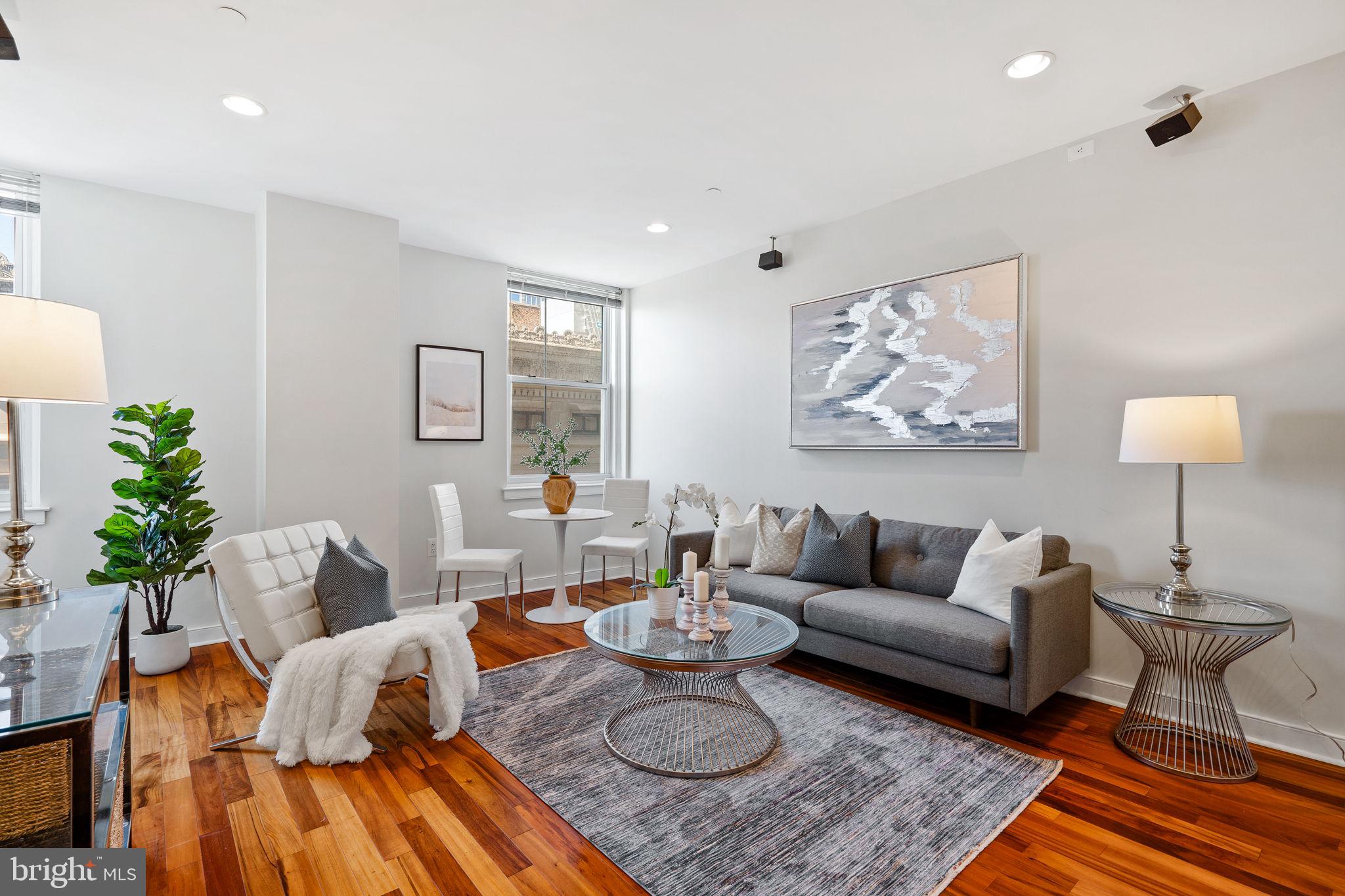 a living room with furniture and a lamp