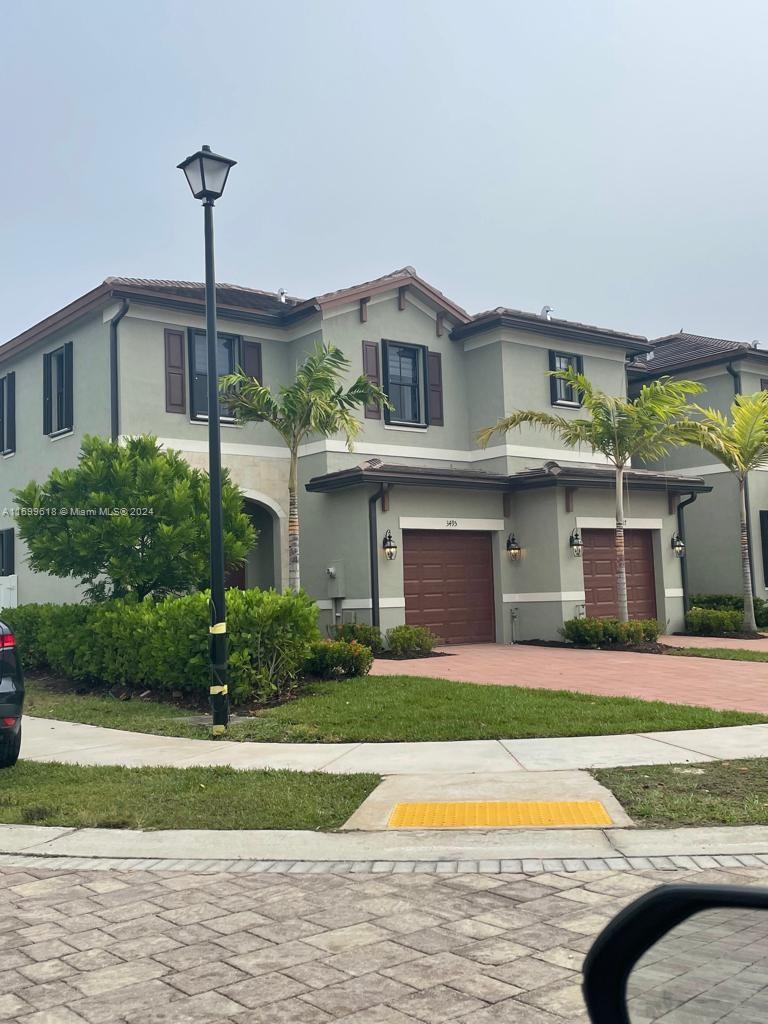 a front view of house with yard and green space