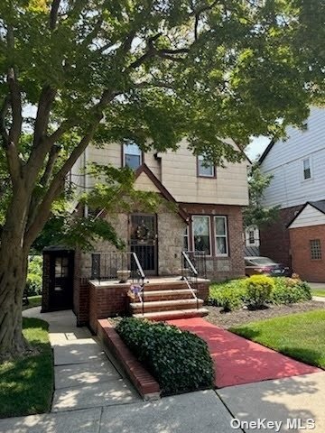 a front view of a house with garden