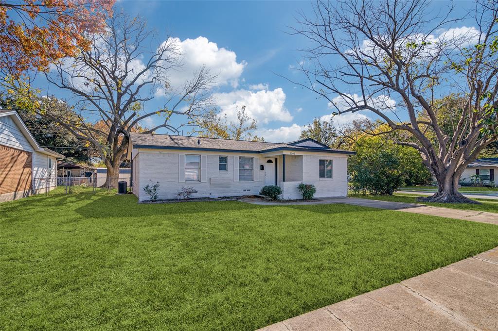 a view of a house with a big yard and large trees