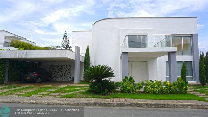 a view of a house with a yard and plants