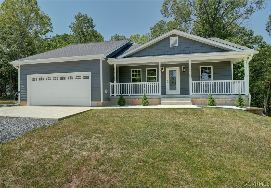 a front view of a house with a garden and yard