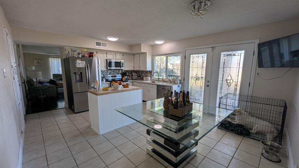 a kitchen with a refrigerator a stove a sink and cabinets