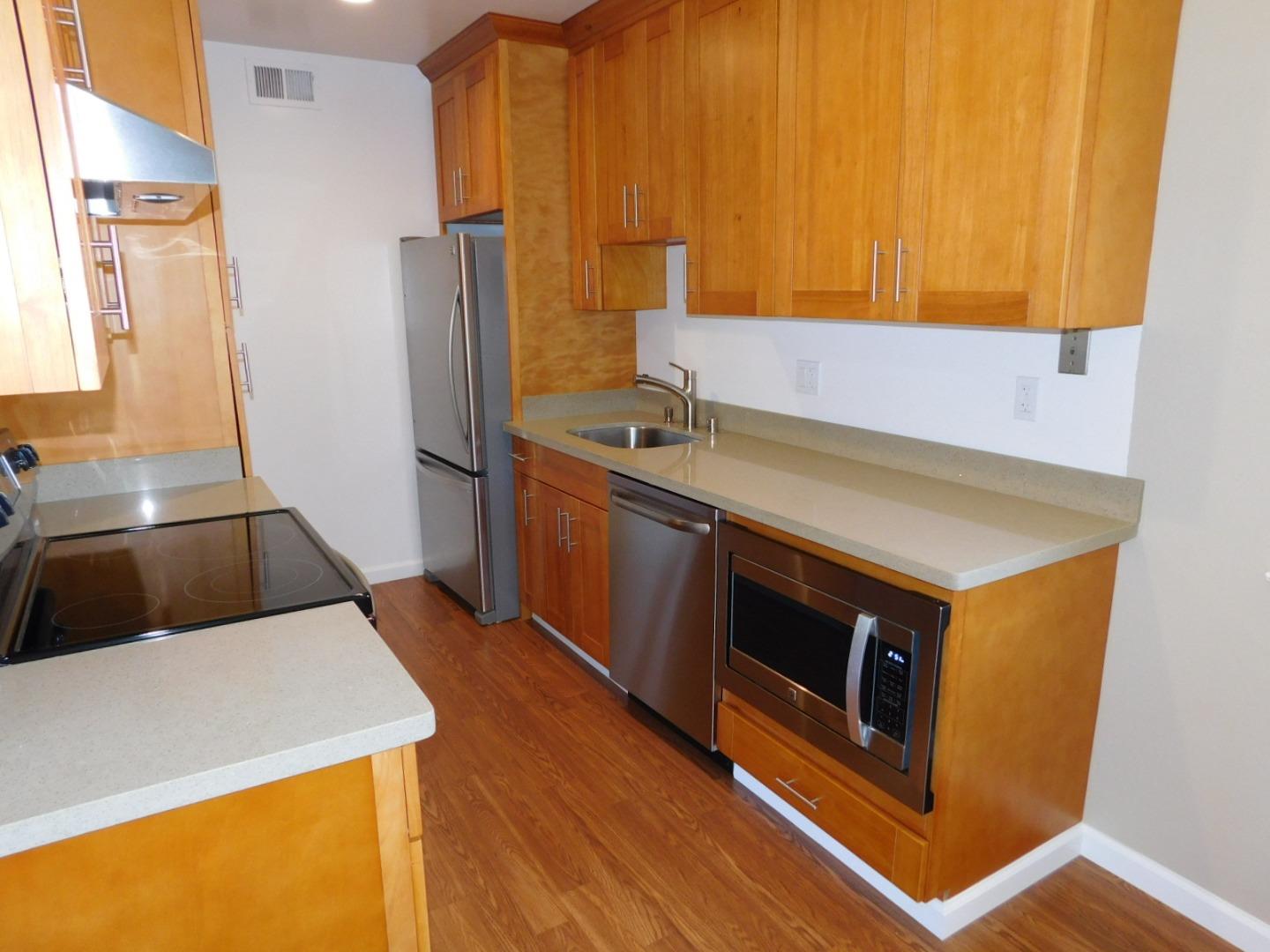 a kitchen with a sink stove and refrigerator