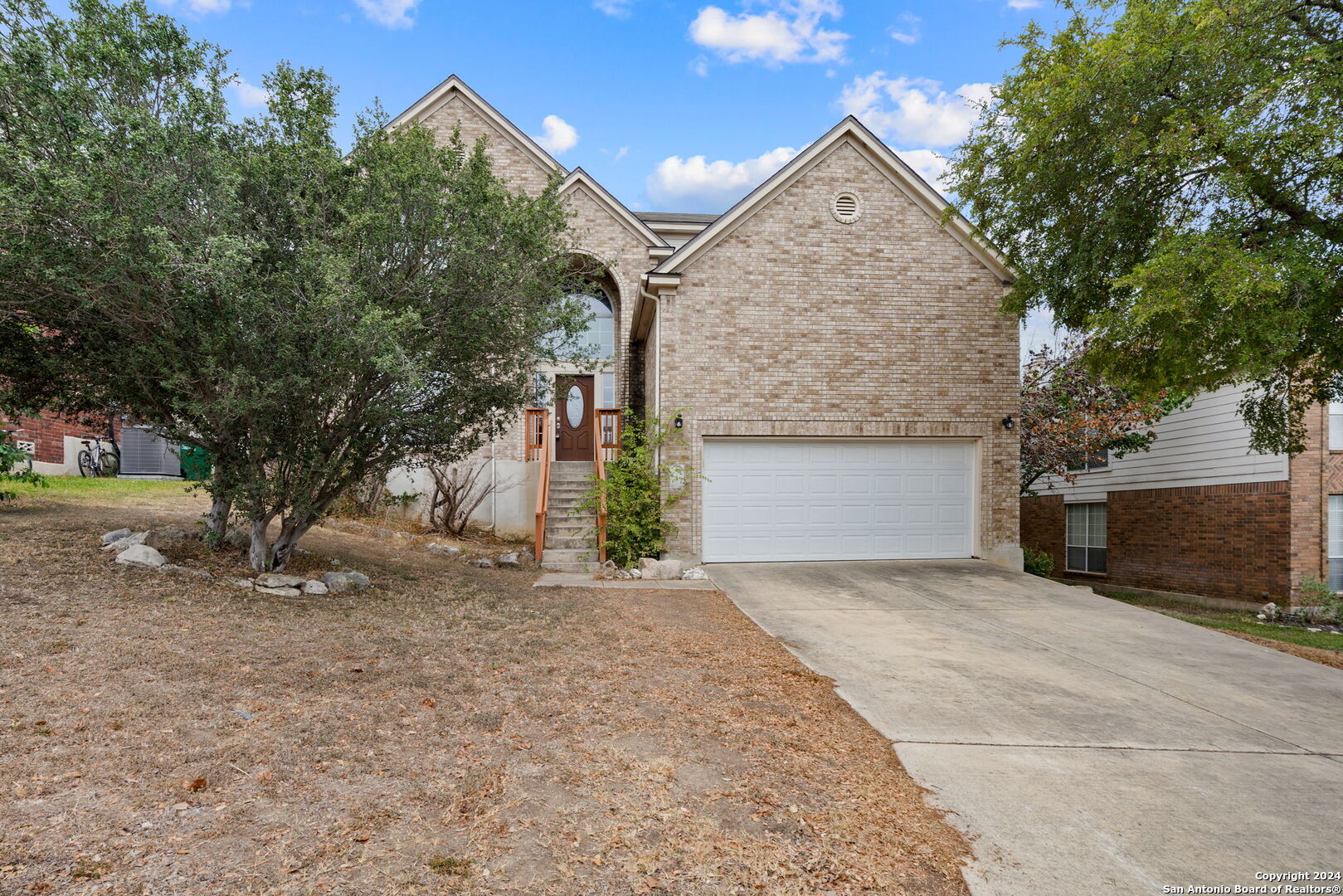 a front view of a house with a yard and garage