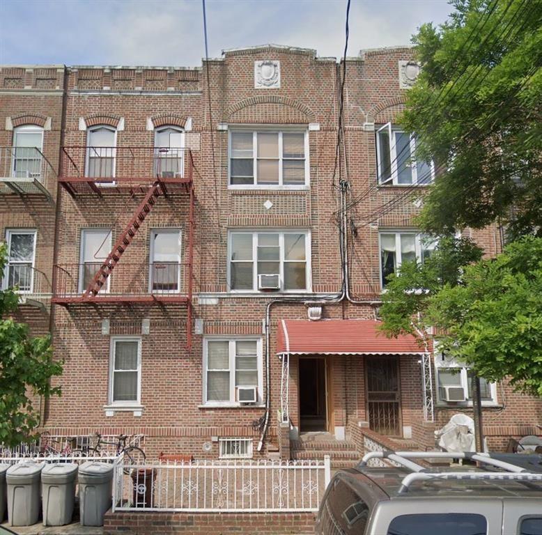 a front view of a residential apartment building with a yard