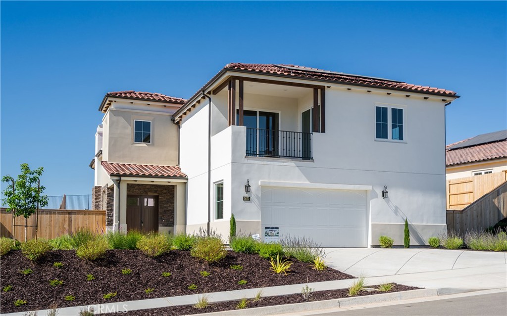 a front view of a house with plants